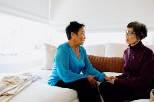 Two women sitting on couch